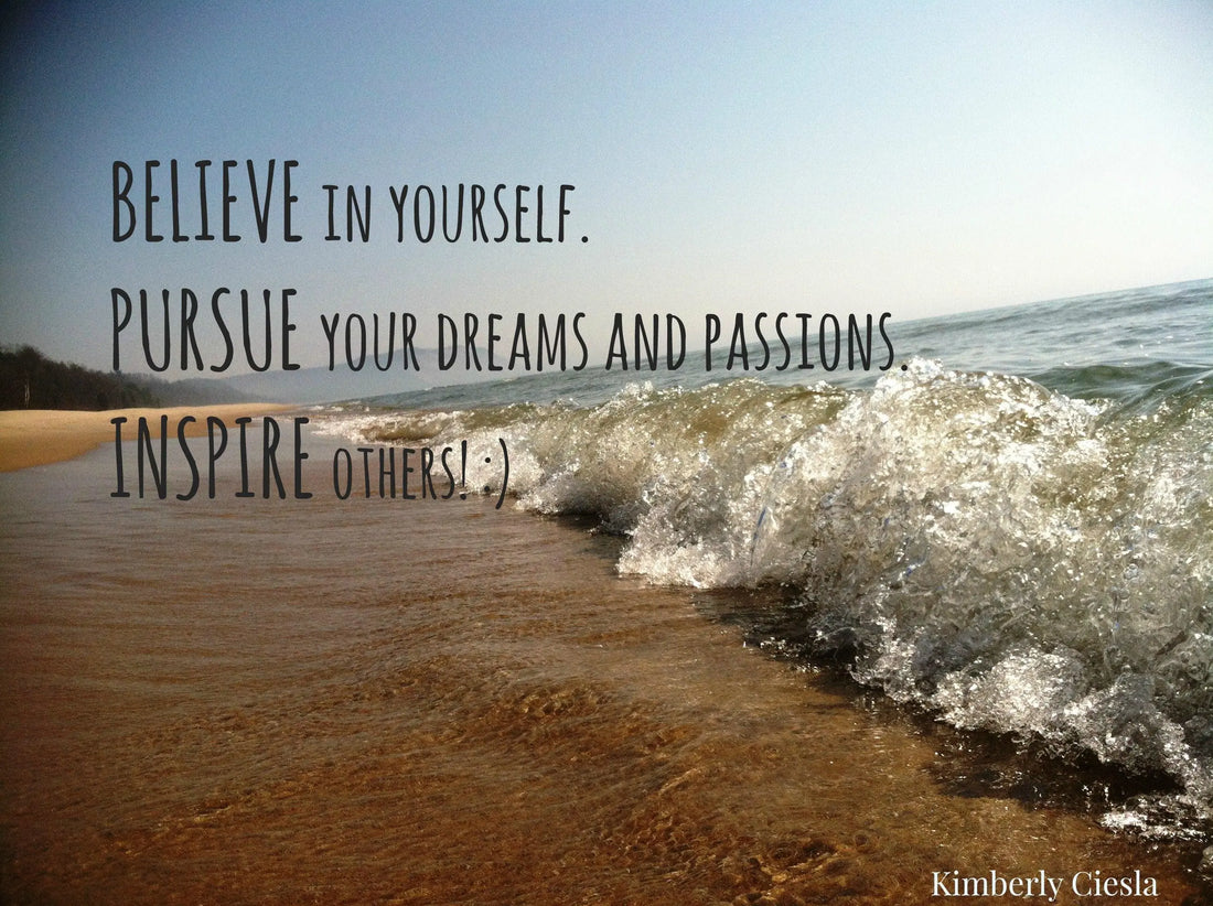 Inspirational quote on sandy beach with ocean waves and blue sky background
