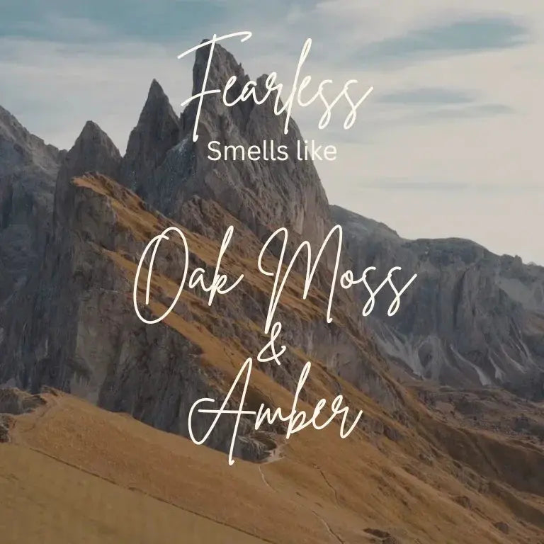 Fearless Oak Moss Amber fragrance text over scenic mountain landscape